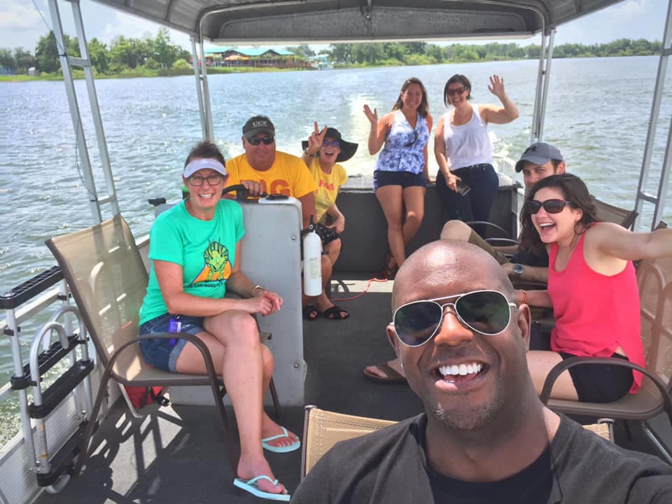 Family enjoying a sunny day on a pontoon boat on Lake Fairview
