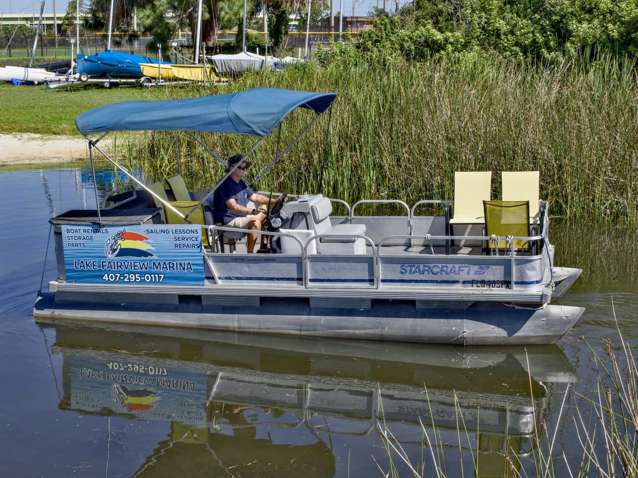 Pontoon boat cruising on spring-fed Lake Fairview