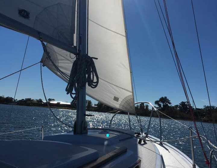 Instructor teaching students on Com-Pac sailboat on Lake Fairview
